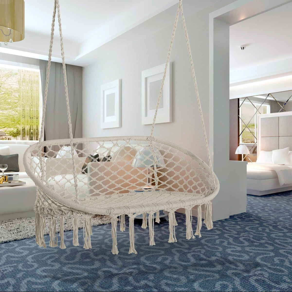 Macrame hammock chair with round net seat, white-beige rope, and hanging tassel fringe.