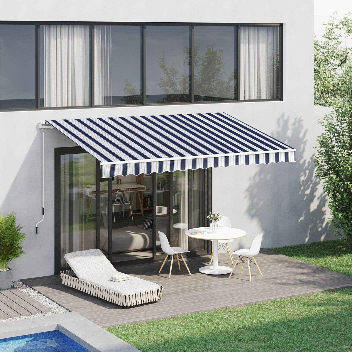Blue and white striped patio awning shading outdoor dining table and lounge chair on deck near pool