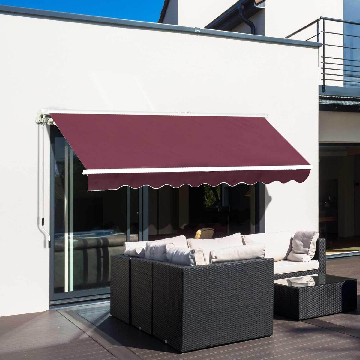 Burgundy retractable awning shading outdoor wicker sofa on modern patio, perfect for garden or home terrace