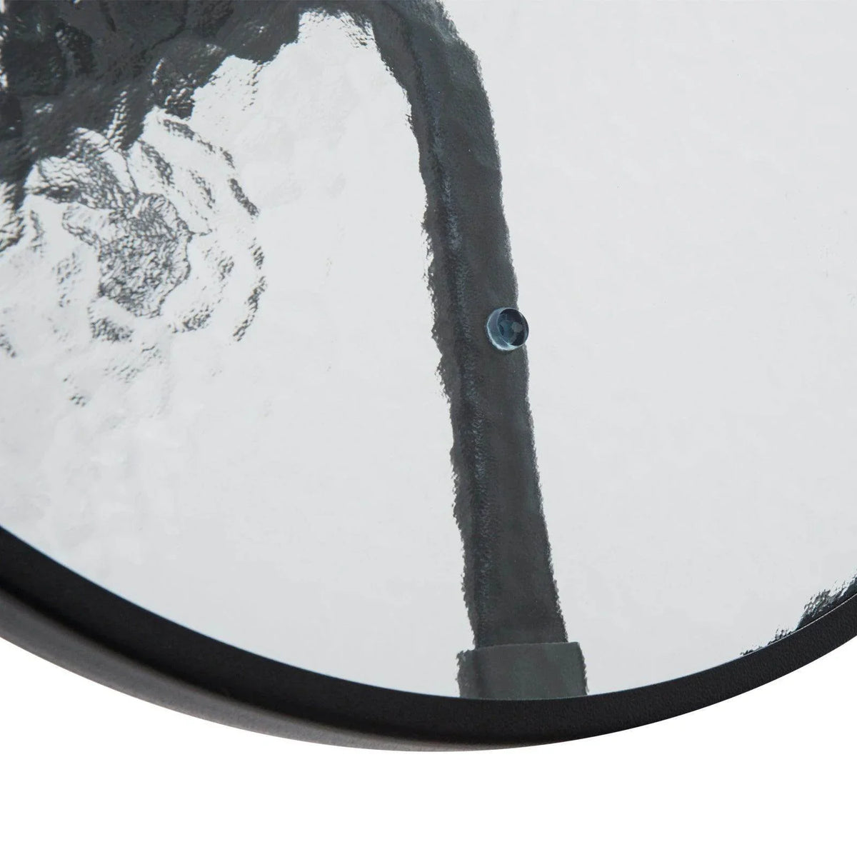 Tempered glass table top close-up with dark trim and small hardware