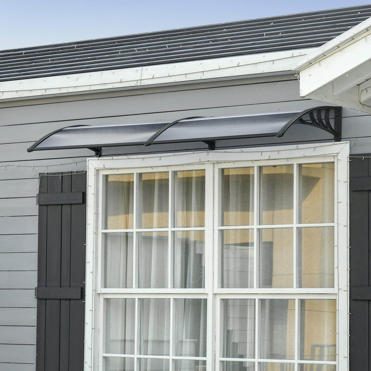 Outsunny outdoor door canopy in dark gray/black with curved roof over a door