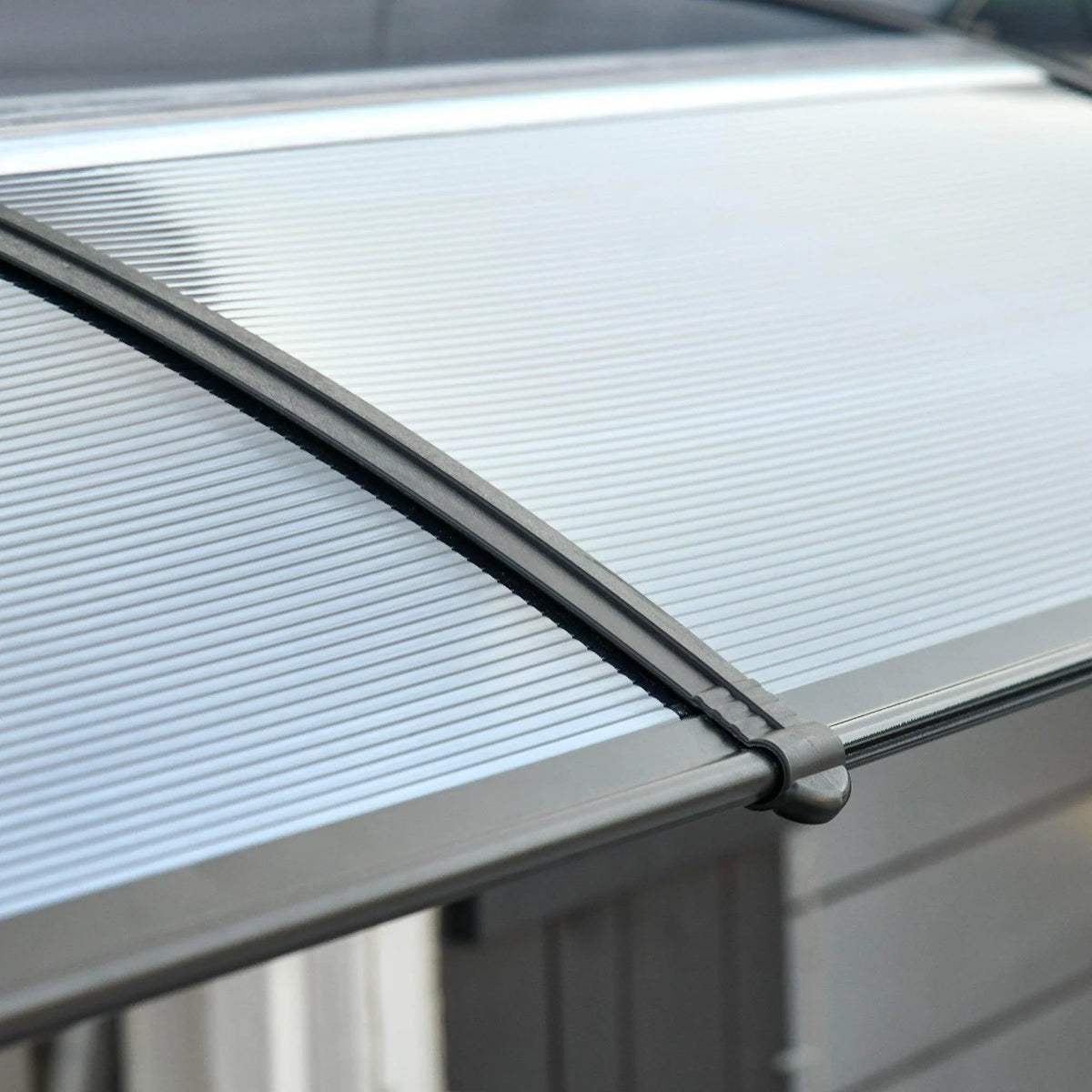 Outsunny outdoor door canopy close-up of sloped roof edge and rounded connecting pipe