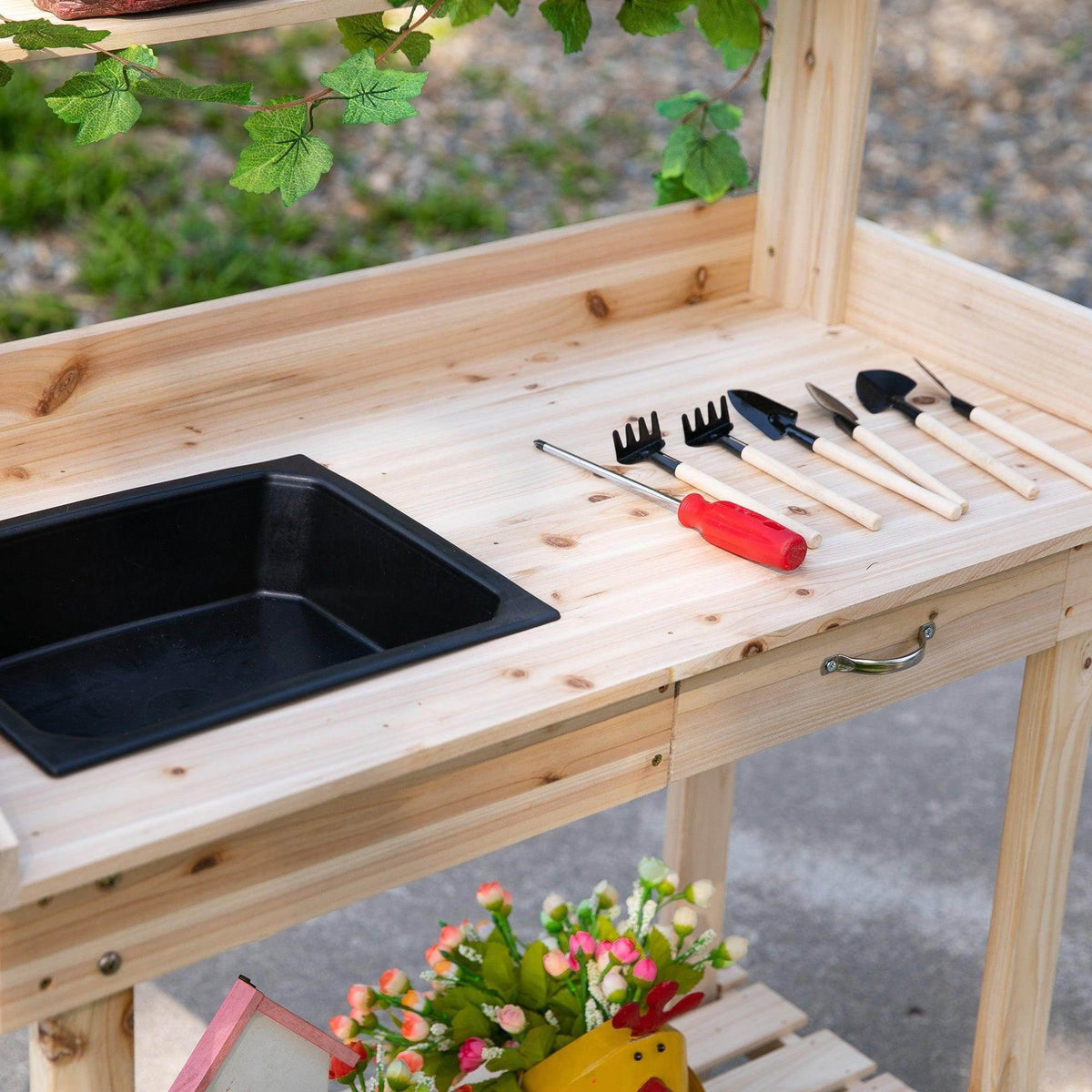 Wooden potting bench countertop with black sink and gardening tools