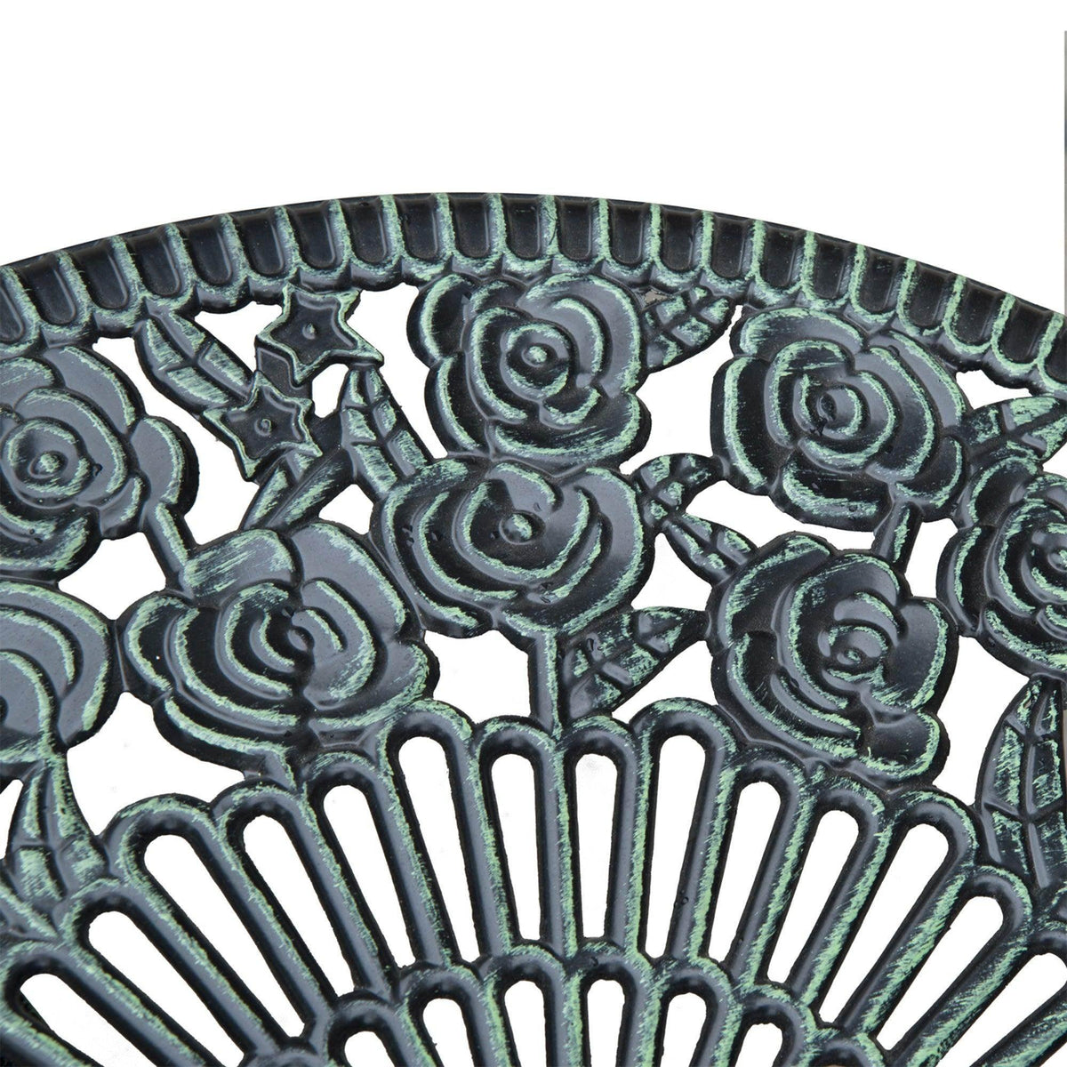 Close-up of a round cast-metal table top with floral rosette and openwork pattern