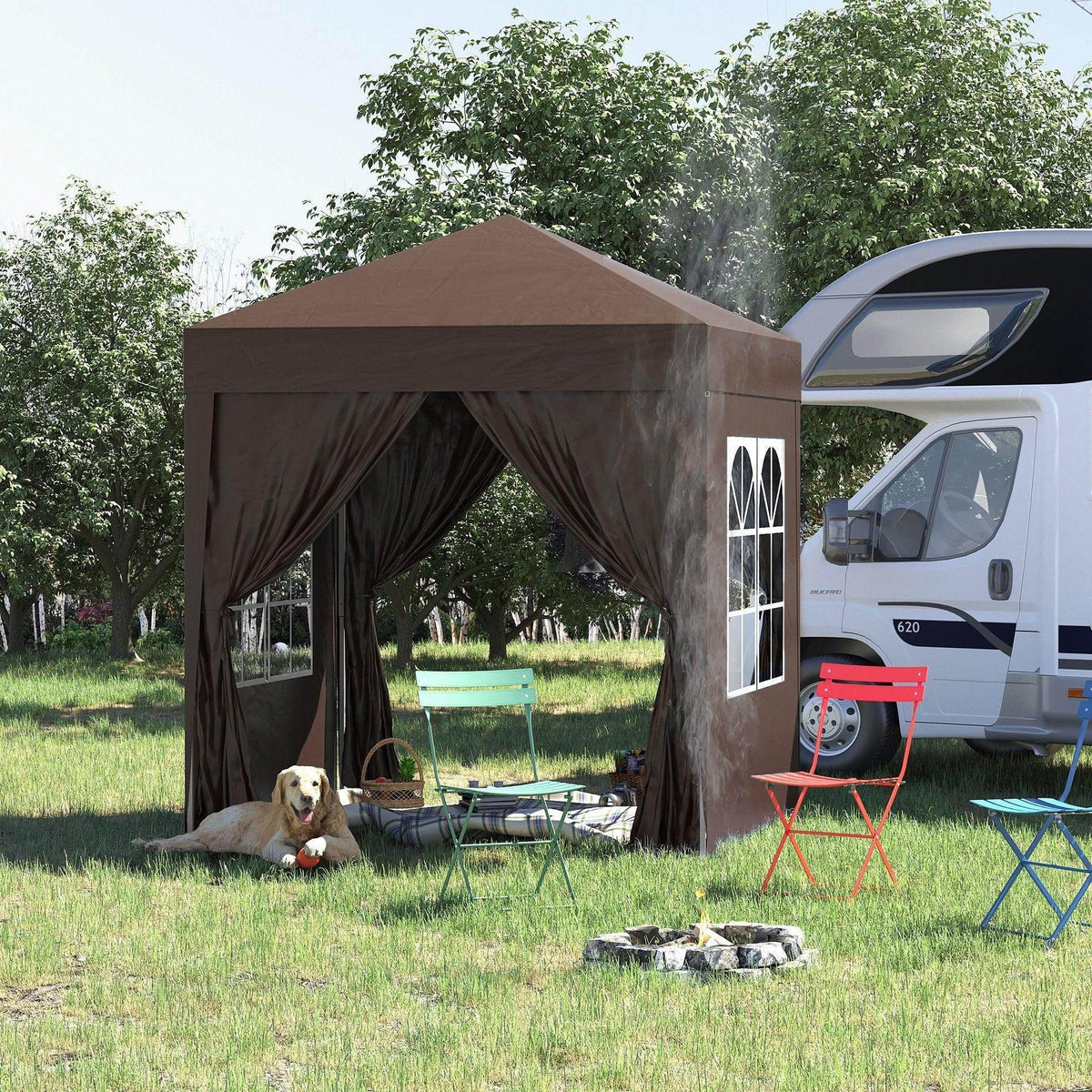 Brown outdoor gazebo with curtains, colorful chairs, and dog beside RV in grassy yard