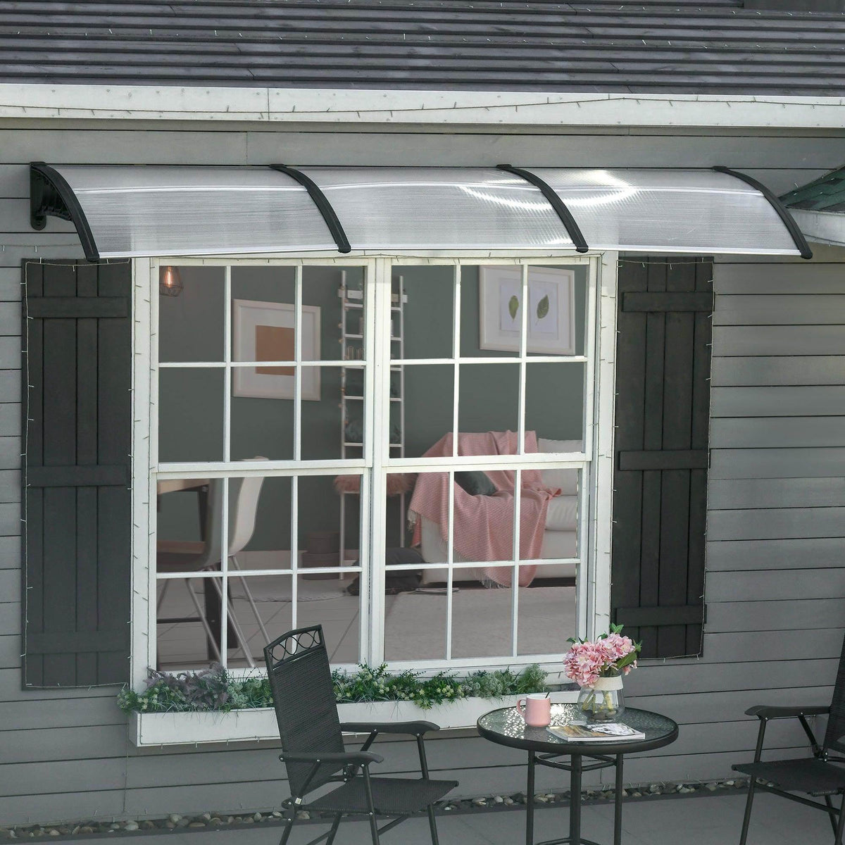Clear polycarbonate porch awning with arched black support brackets