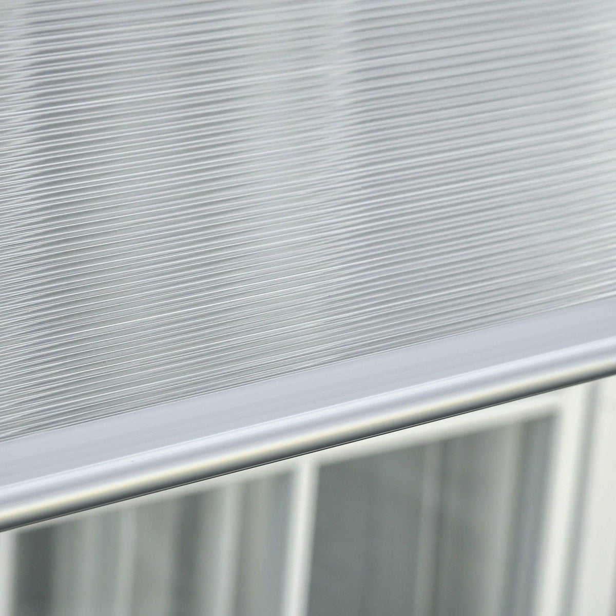 Clear ribbed polycarbonate awning panel with silver mounting rail