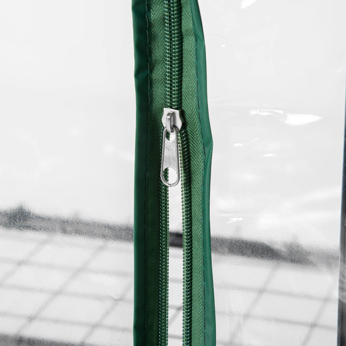 Green PE greenhouse cover with zipper pull and metal track detail for opening