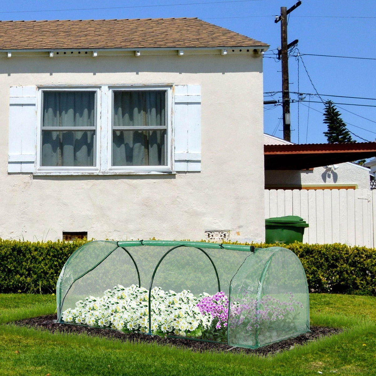 Portable tunnel greenhouse with green PE cover and steel frame, raised bed garden display