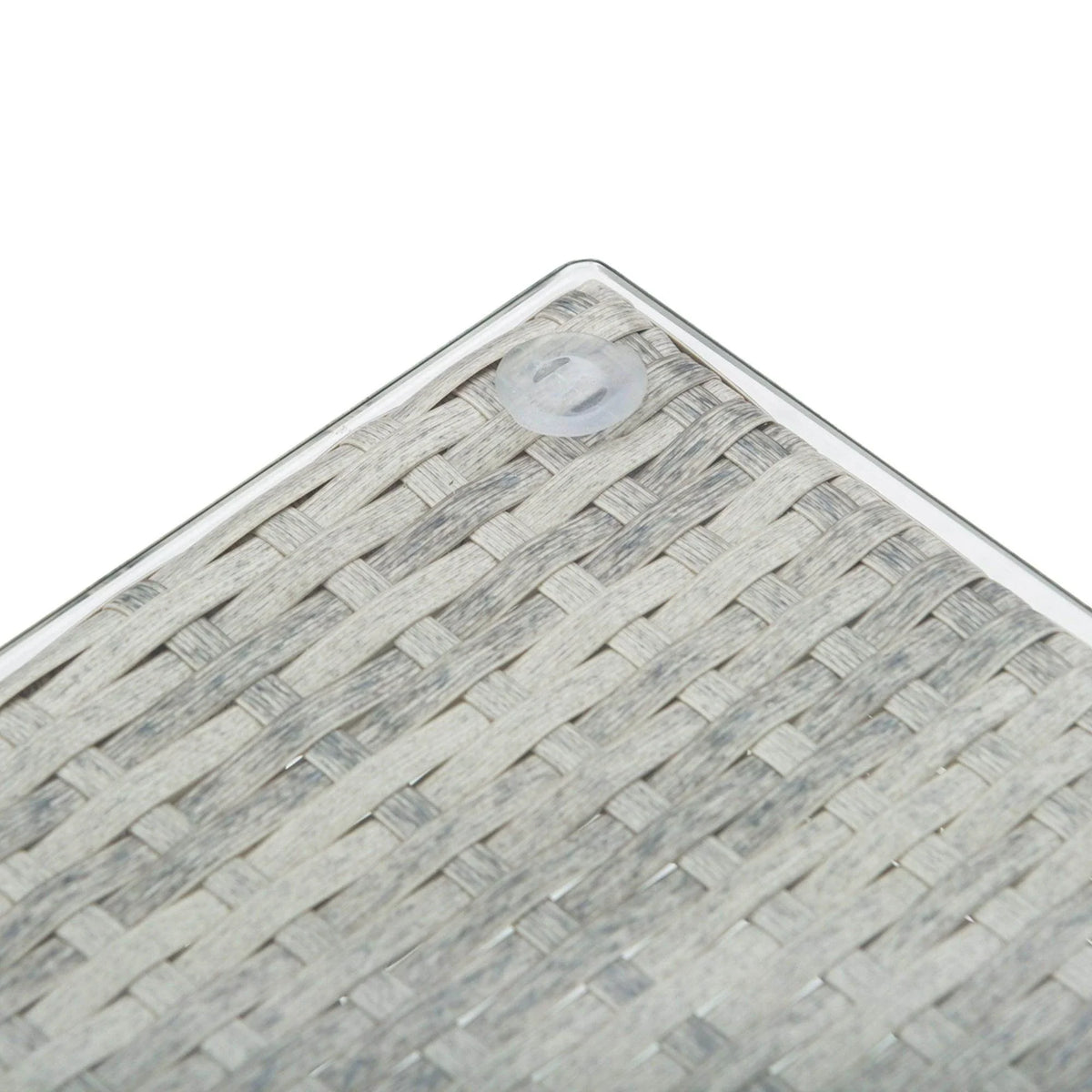 Woven rattan tabletop corner detail in light gray with tight braid pattern