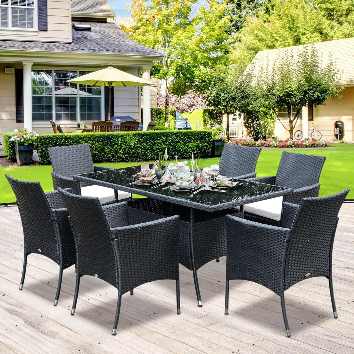 6-seat outdoor dining set with glass-top table and dark woven chairs