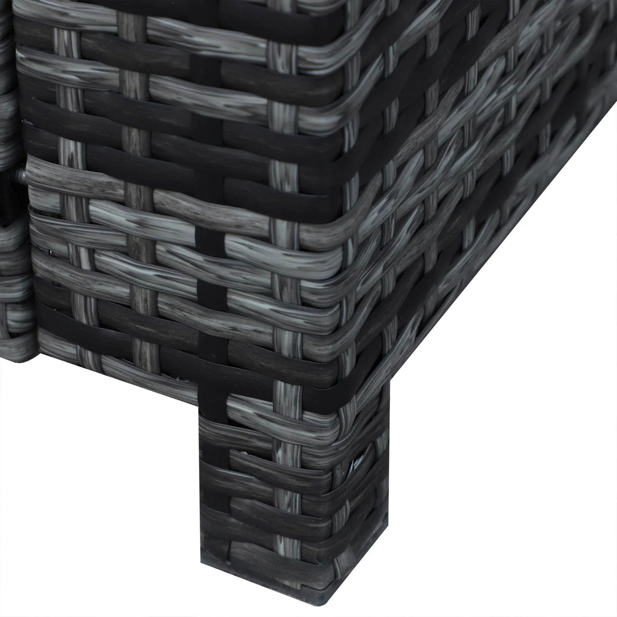 Corner of dark grey woven rattan sofa frame with rounded arm and stitched cushions