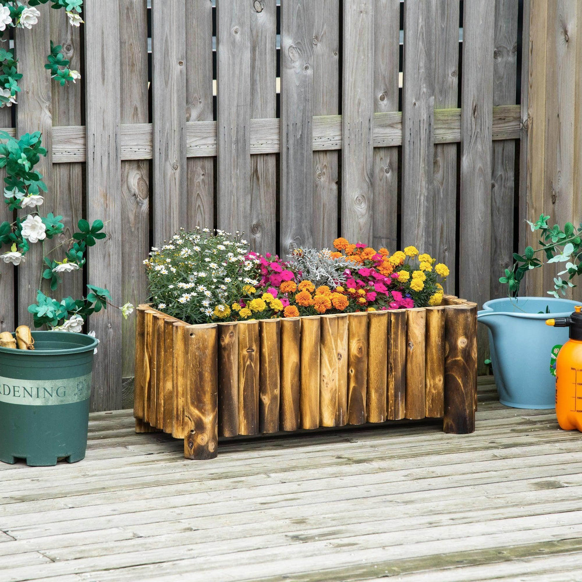 Rectangular wooden planter box filled with colorful flowers in a backyard