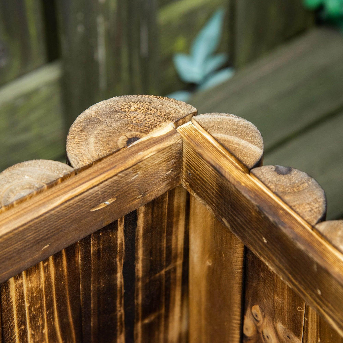 Rectangular wooden planter box corner joint with weathered slat texture