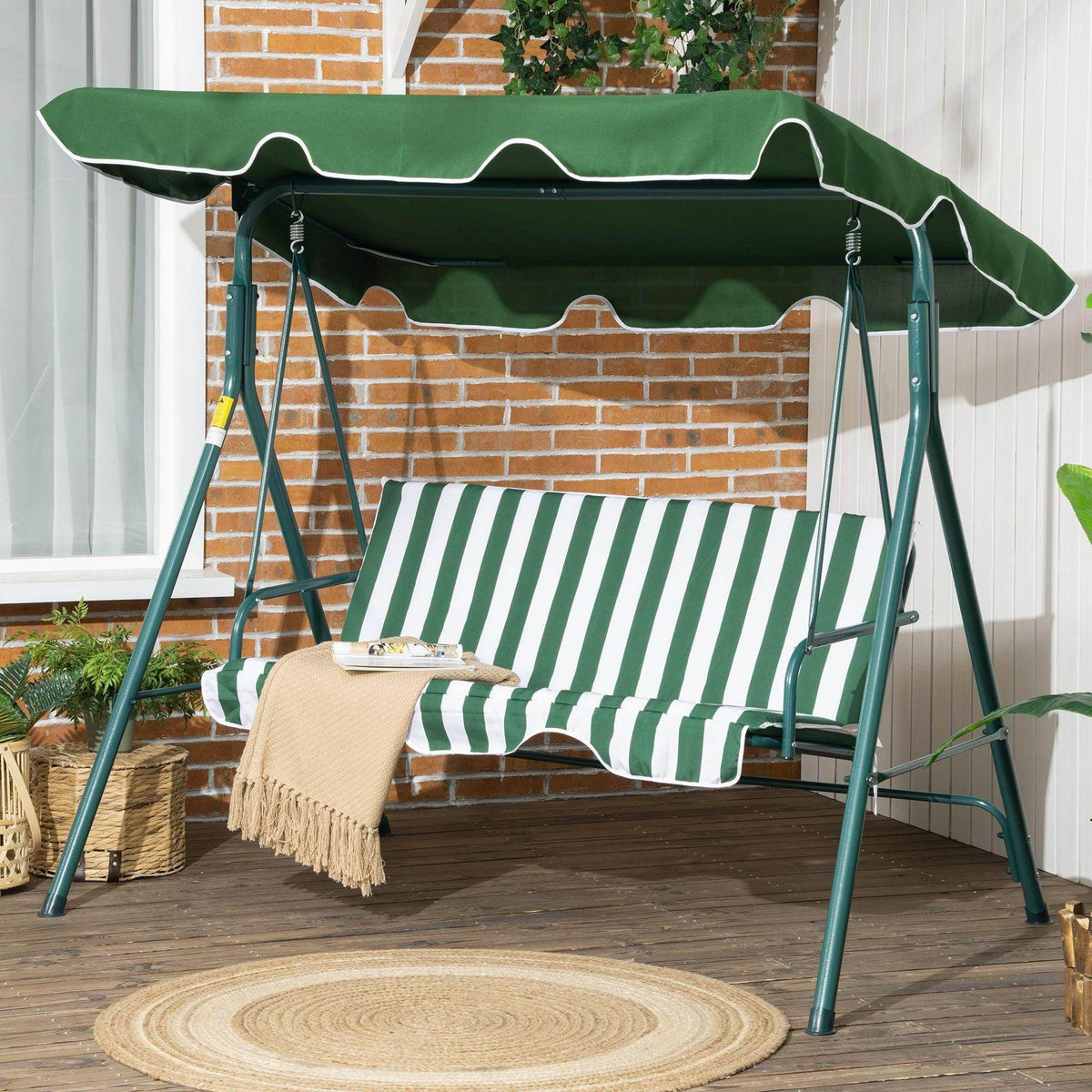 Green swing chair with adjustable canopy, striped bench cushion, steel frame