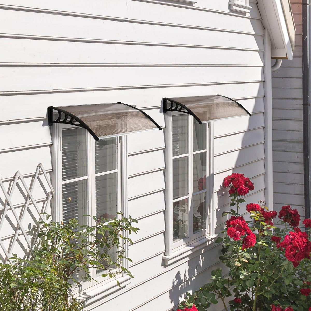 Window canopy with smoke-tinted panel and black curved supports, mounted above windows
