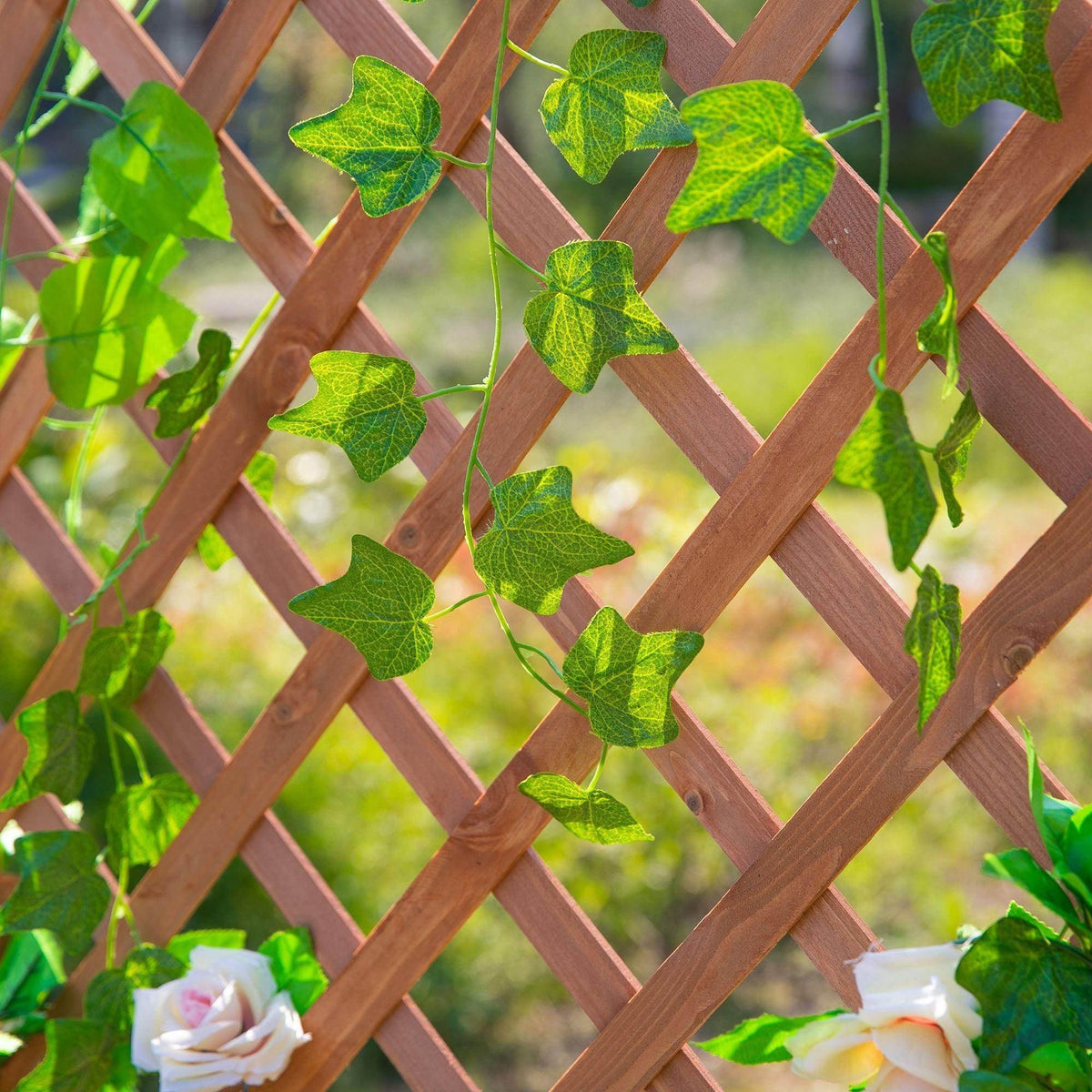 Wooden lattice trellis panel with green climbing leaves