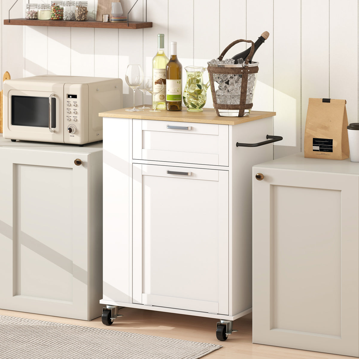 White rolling kitchen storage trolley with cabinet doors, drawers, and black pull handles