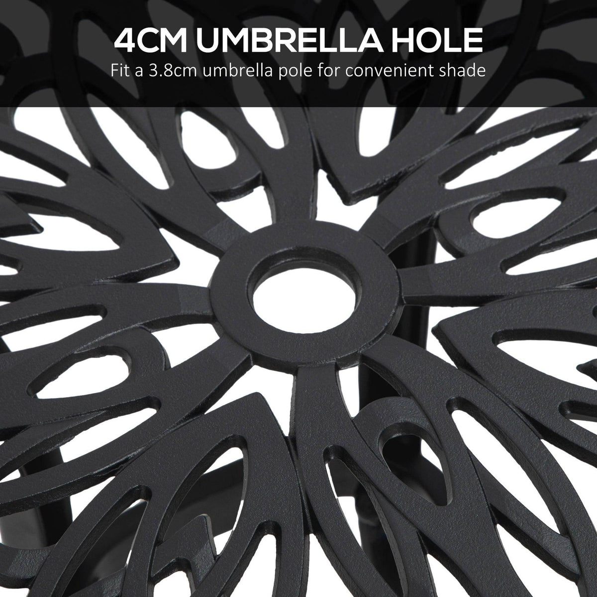 Close-up of black umbrella hole in decorative cast aluminum table top