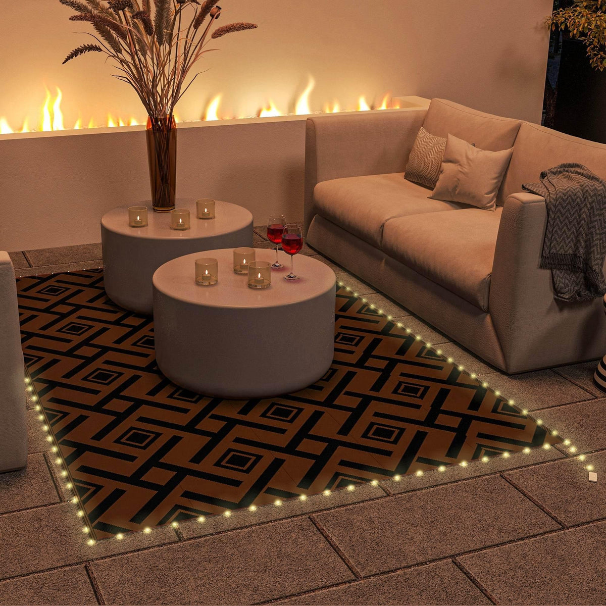 Reversible outdoor rug with LED edge lights, brown and black geometric pattern