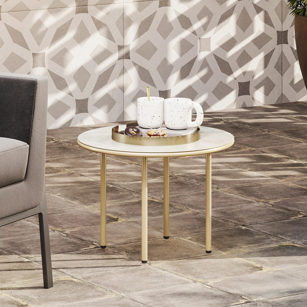 Beige round coffee table with faux marble top and gold steel legs in living room
