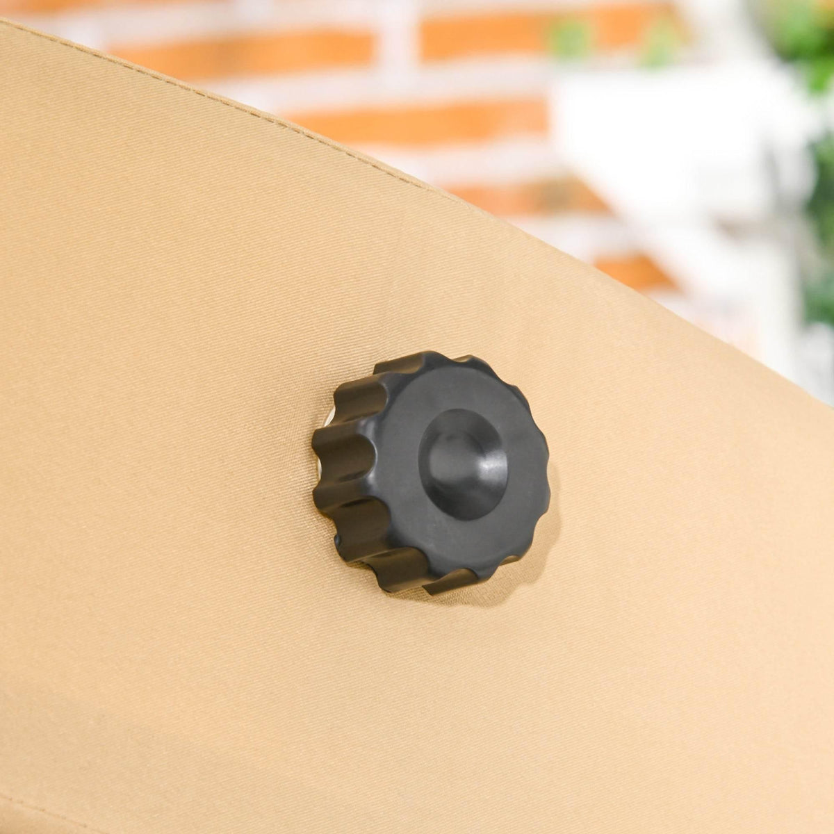 Beige canopy adjustment knob on a swing bench canopy top