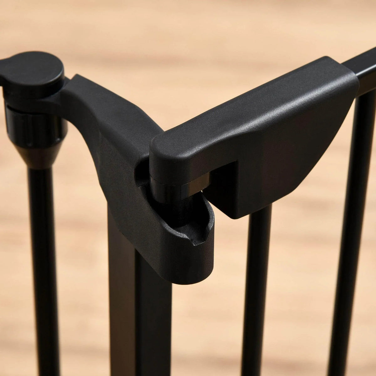 Auto-close pet gate door latch mechanism on black metal bars