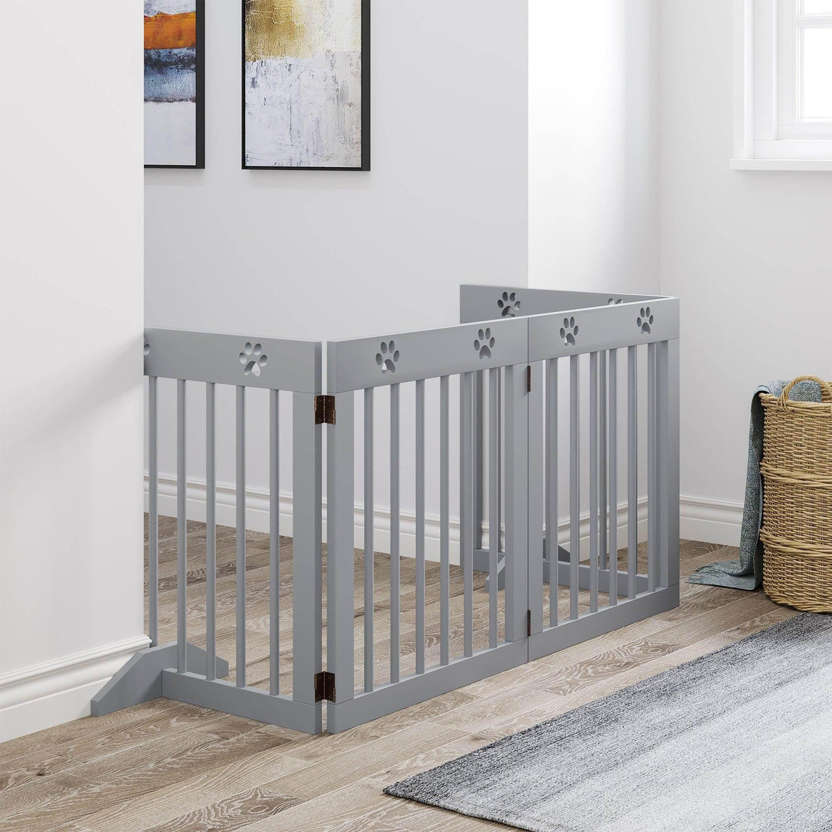 Freestanding gray pet safety gate with vertical bars and paw-print panels