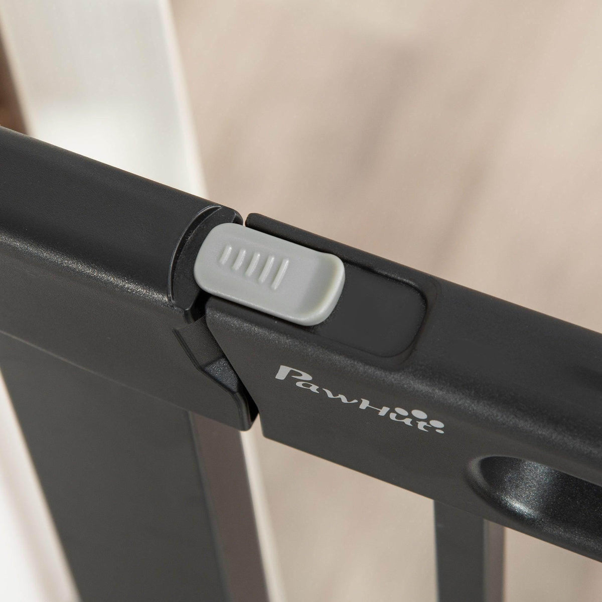 PawHut branded black gate latch with white slider release, close-up