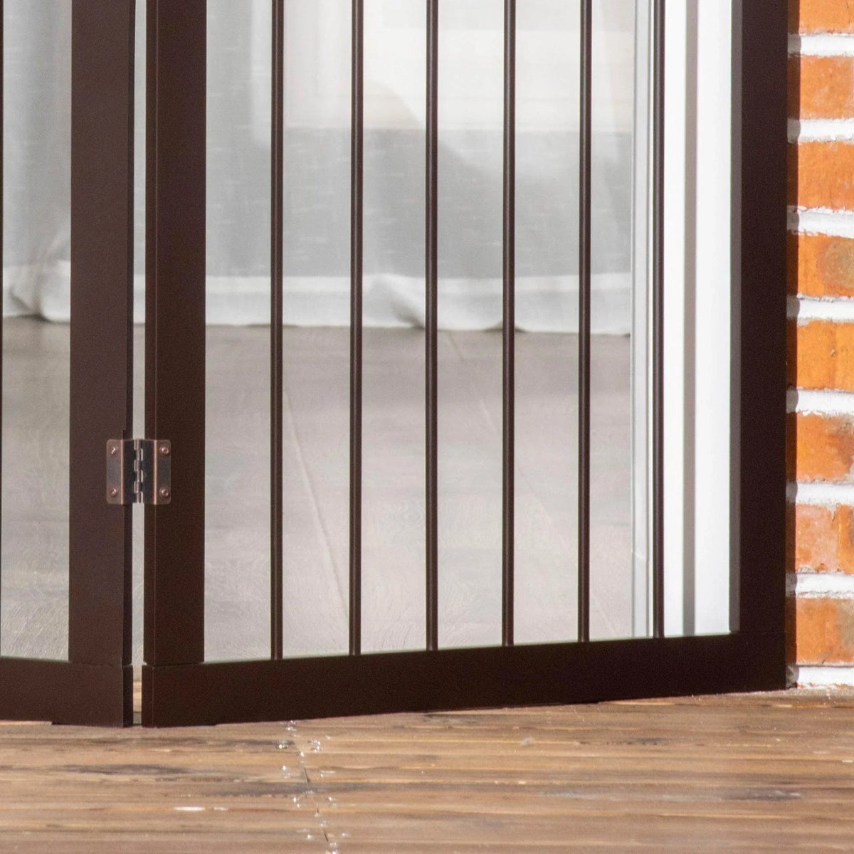PawHut dog gate close-up with vertical bars and dark base frame