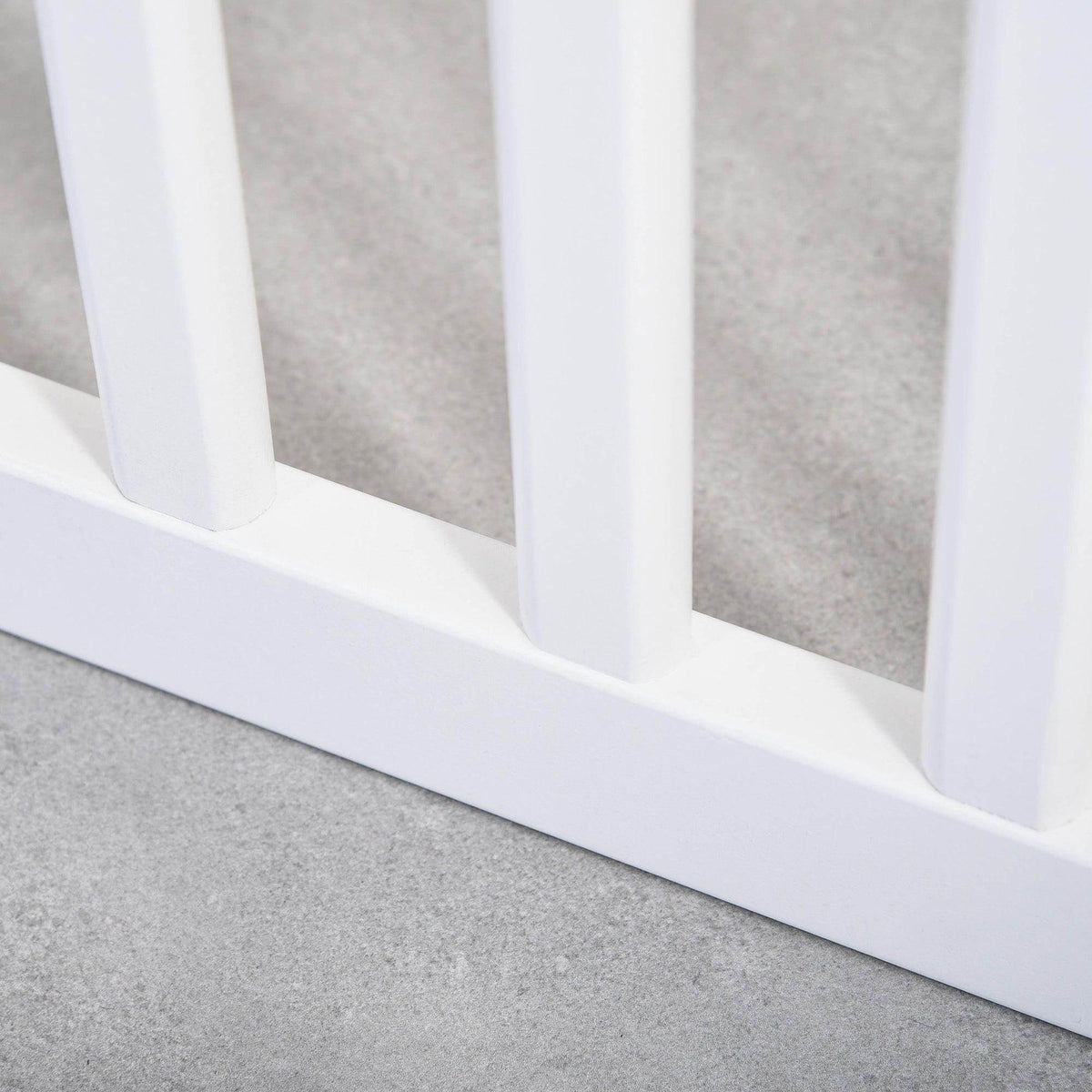 White pet gate lower rail with vertical bars and smooth base trim