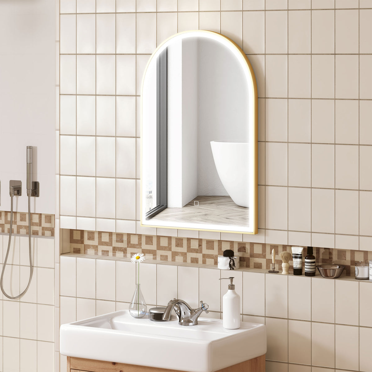 Arched gold LED bathroom mirror reflecting tub above white sink