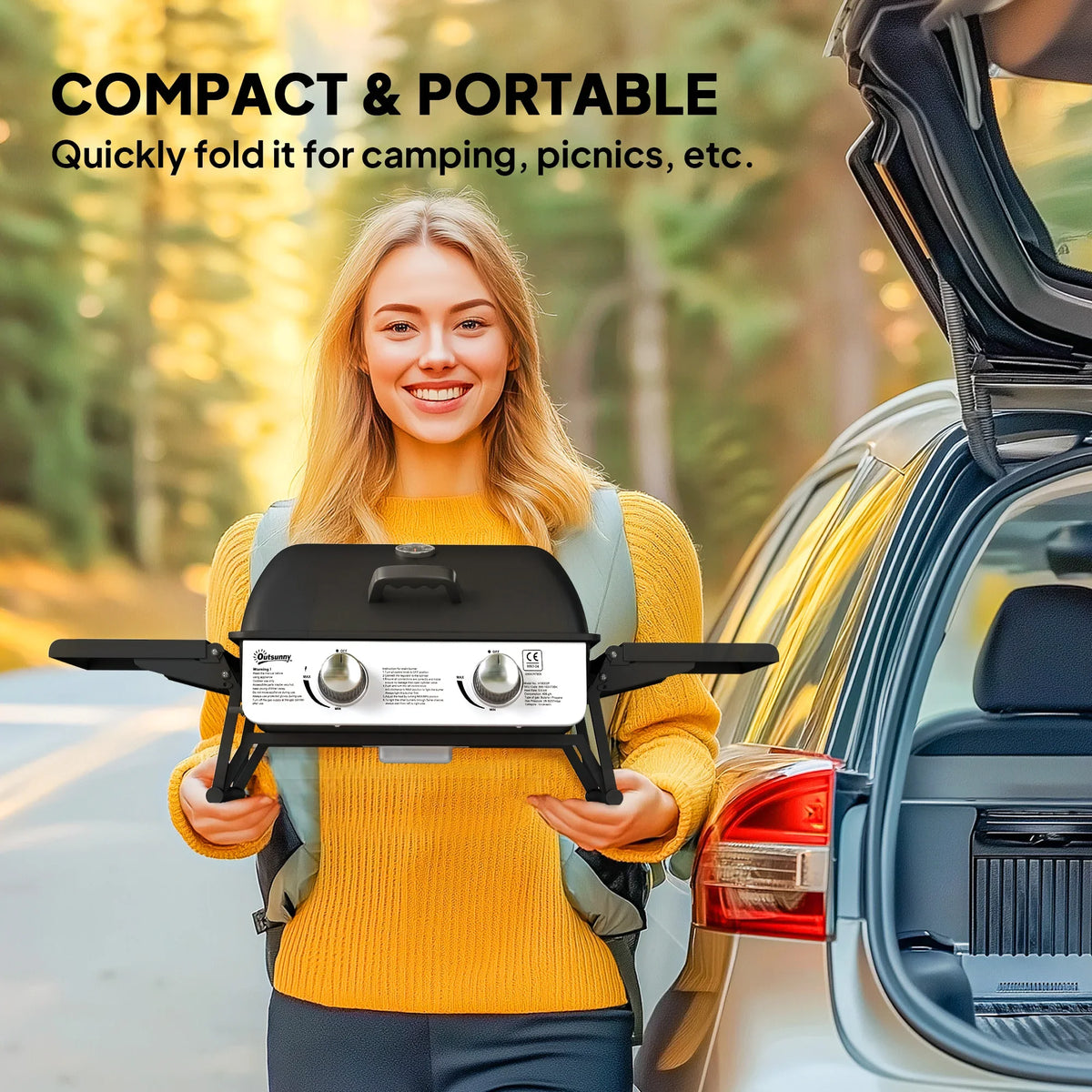 Black compact gas grill with closed lid and foldable legs, front control knobs
