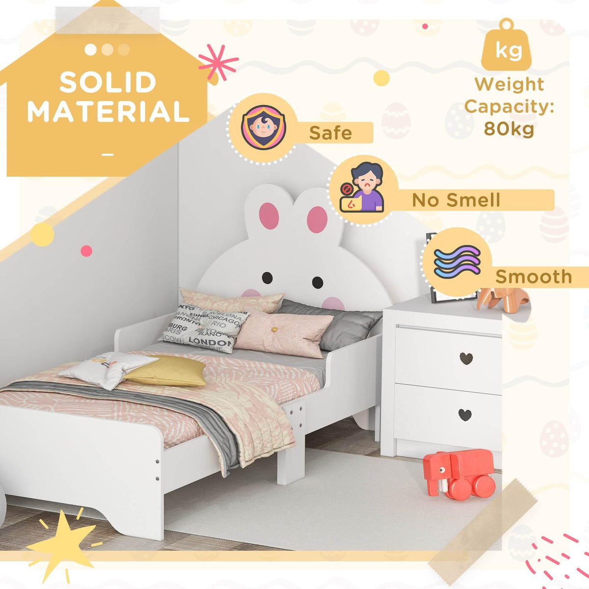 White toddler bed frame with bunny headboard and stacked bedding on the mattress base