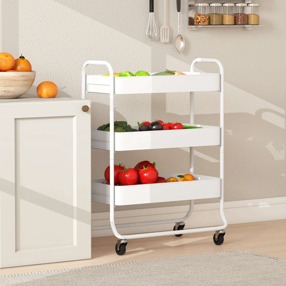 White 3-tier rolling utility cart with mesh shelves holding produce, caster wheels