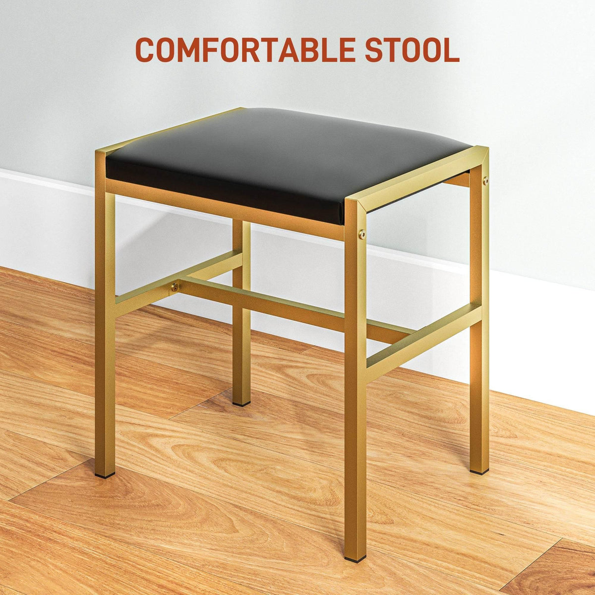 Black cushioned vanity stool with gold metal frame and padded top