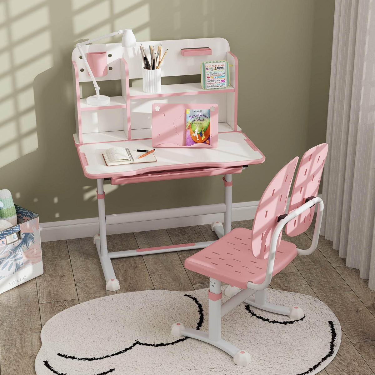 Pink children's study desk and chair set with open storage and reading rack