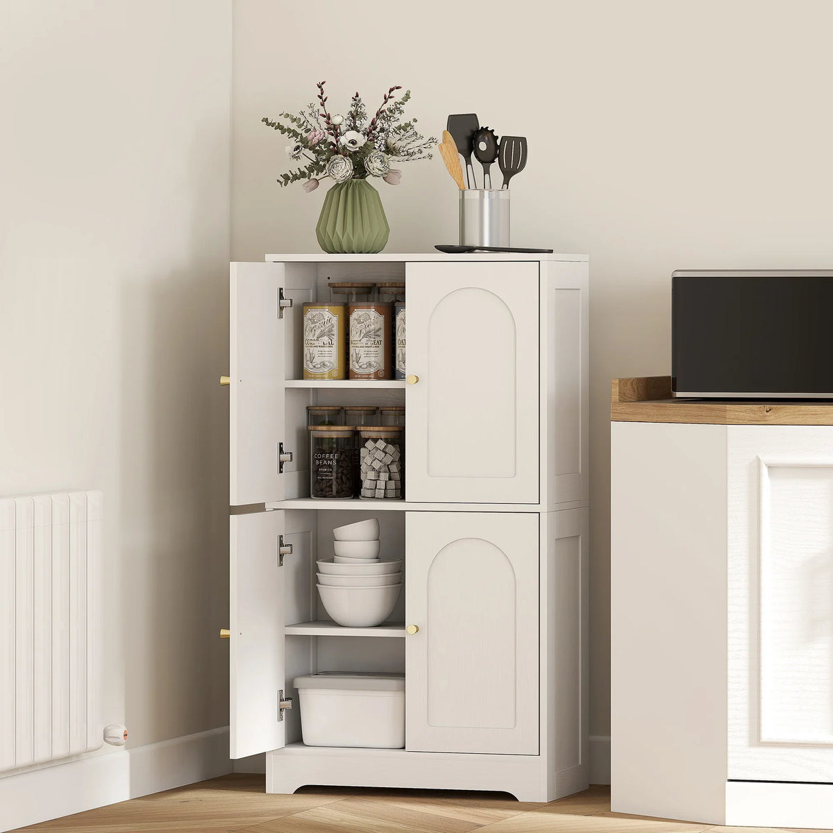 White 4-door kitchen storage cabinet with arched door panels and gold-tone handles, open shelving
