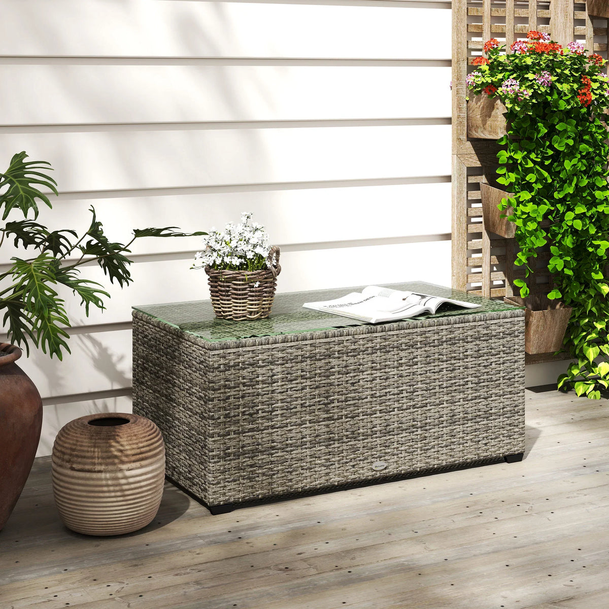 Dark grey rattan outdoor side table with clear tempered glass top, rectangular shape