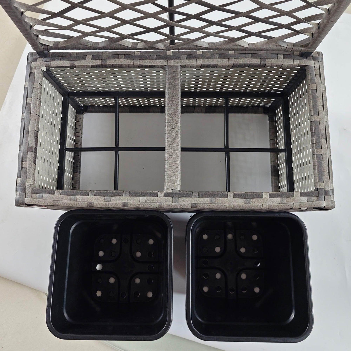 Open grey rattan planter with black trellis, two black square plant boxes inside