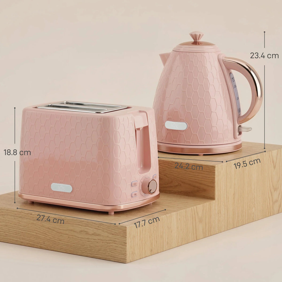 Light pink honeycomb electric kettle and matching toaster set on wooden base