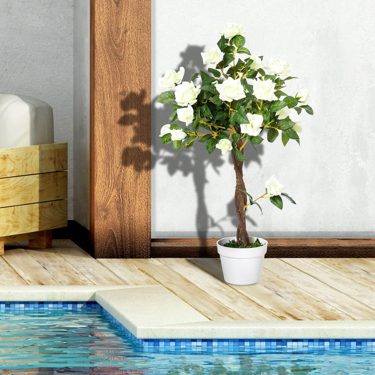 Artificial white rose tree with green leaves and white blooms in a white pot