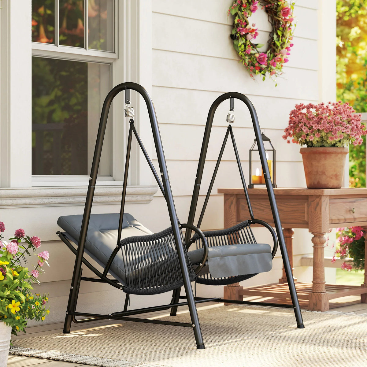 Dark grey hanging swing chair with woven seat and light grey seat cushion