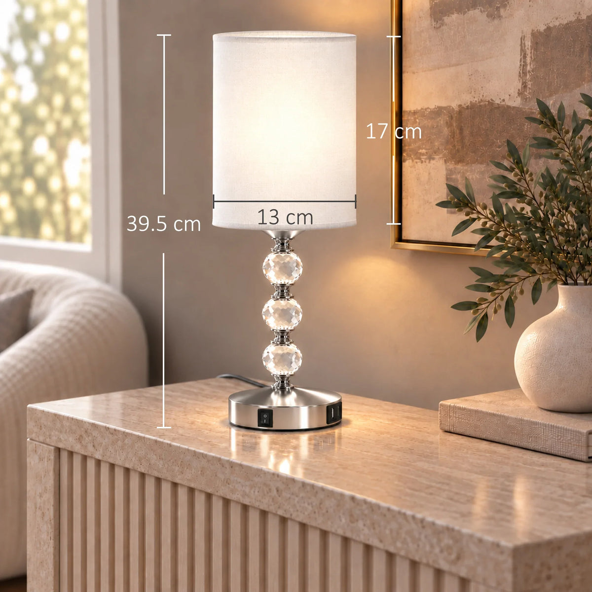 Crystal bedside table lamp with white shade on a round metal base