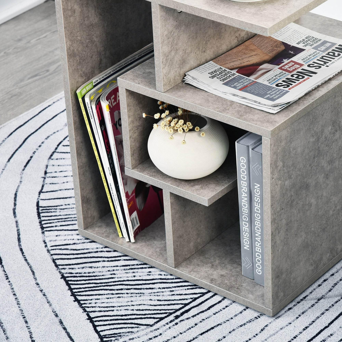 Gray cement-finish 3-tier side table corner showing open shelf compartments