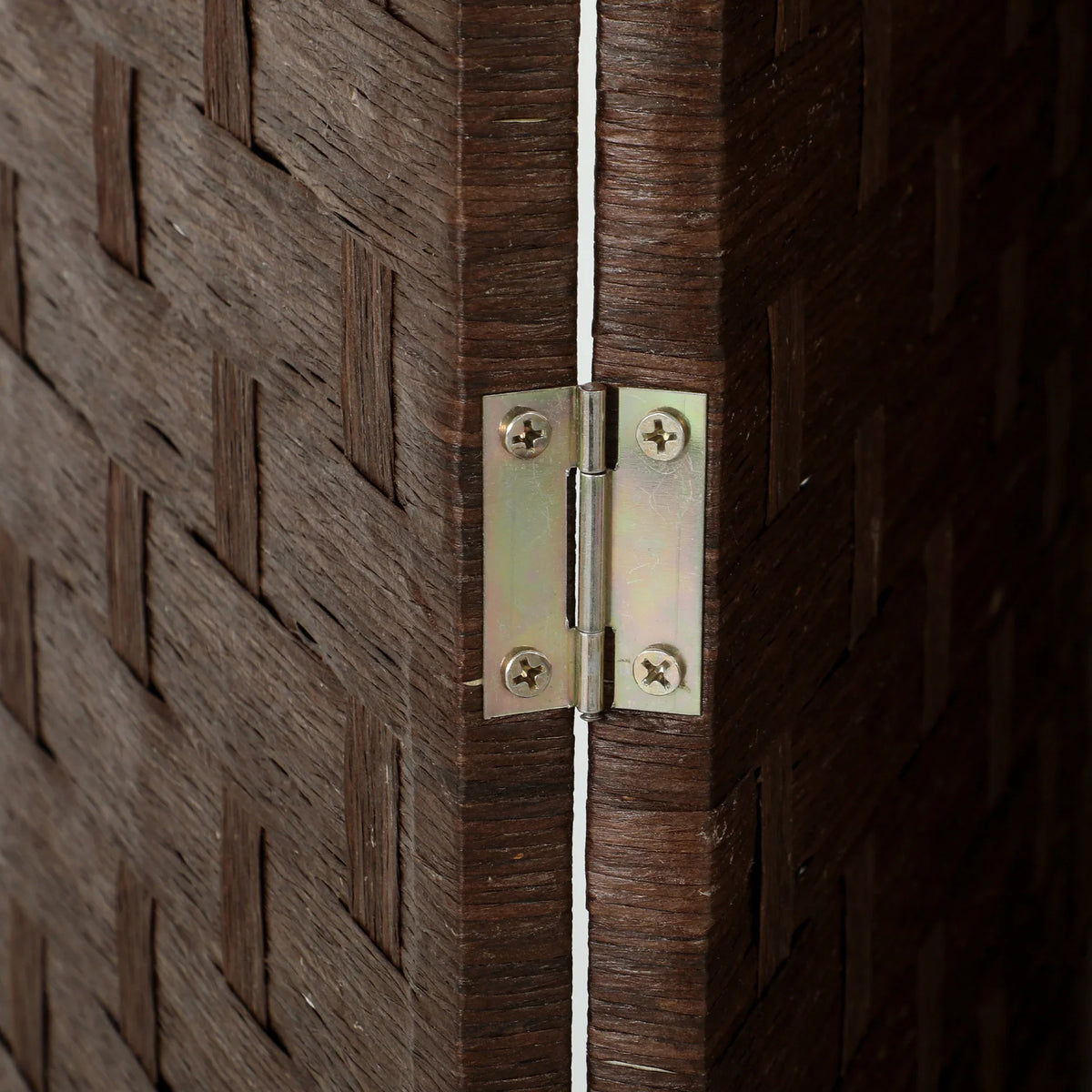Brass-tone metal hinge on dark brown folding privacy screen
