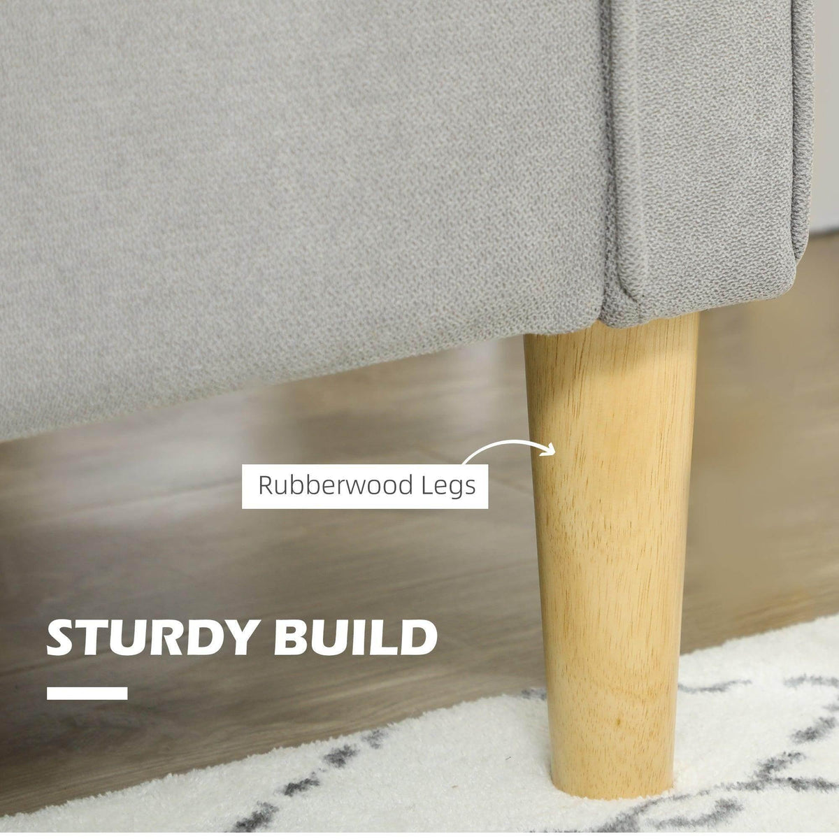 Light grey sofa with tapered rubberwood legs and stitched upholstery at arm