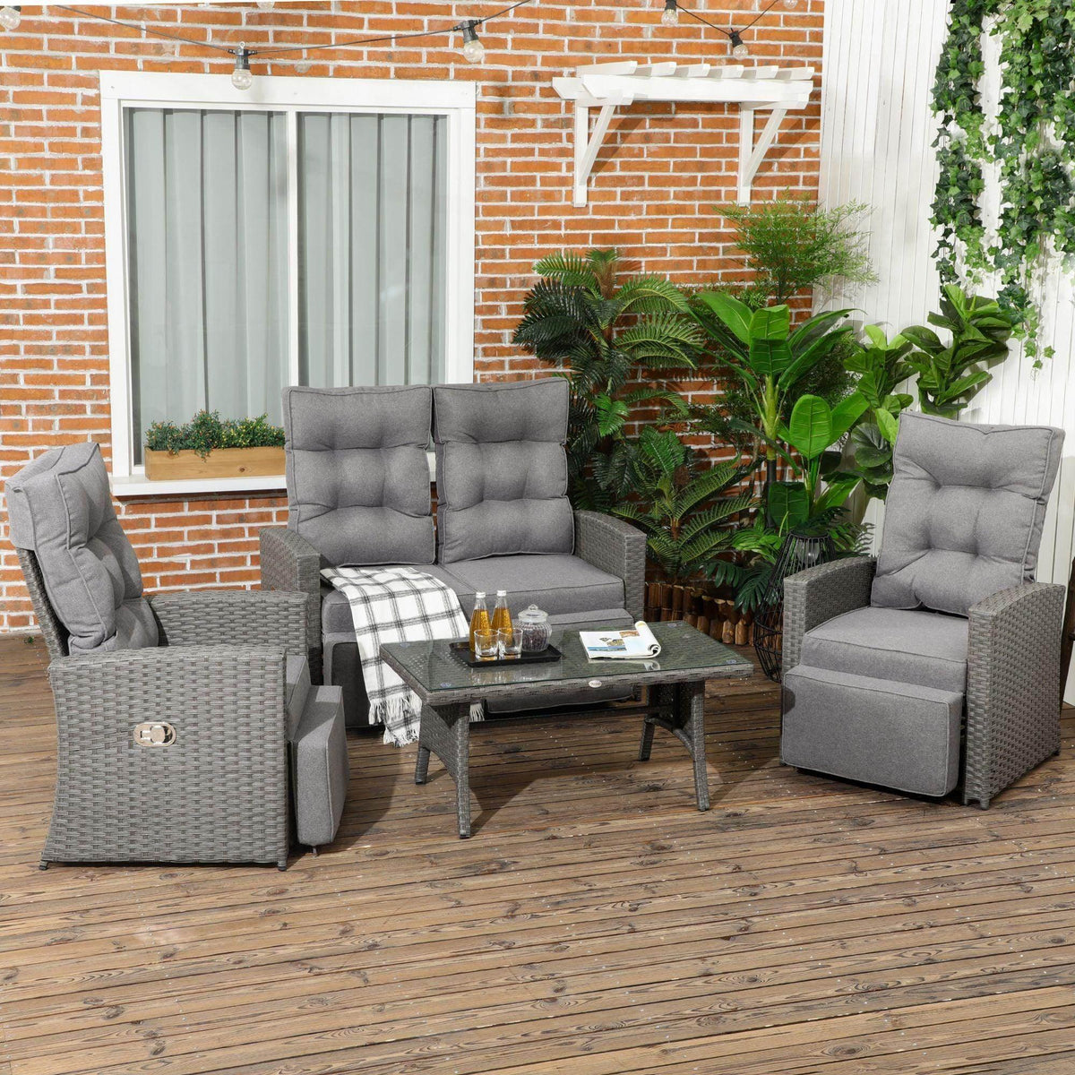 Grey rattan garden seating set with sofa, glass table, and two armchairs with cushions
