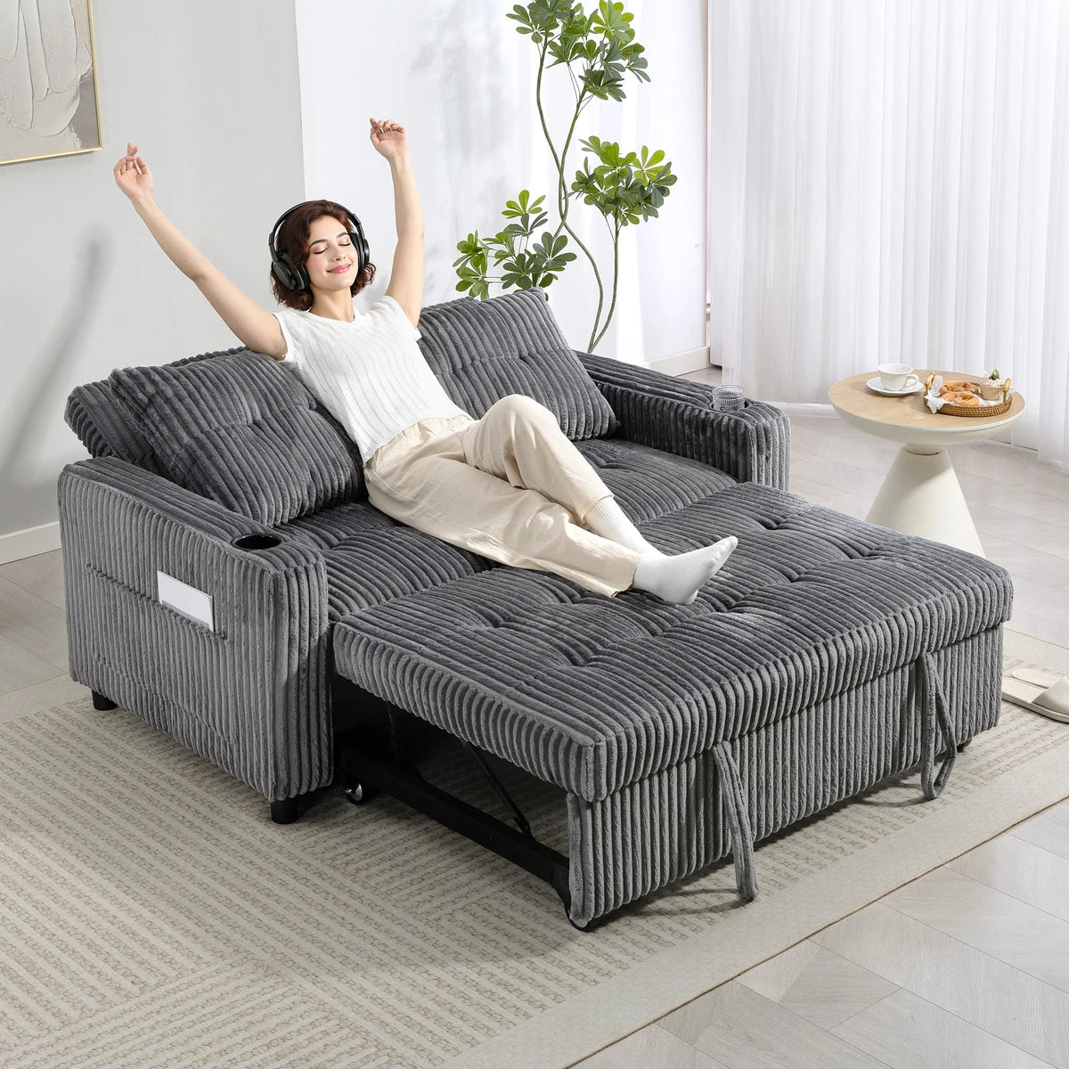 Charcoal grey corduroy sofa bed with pull-out mattress extended for lounging