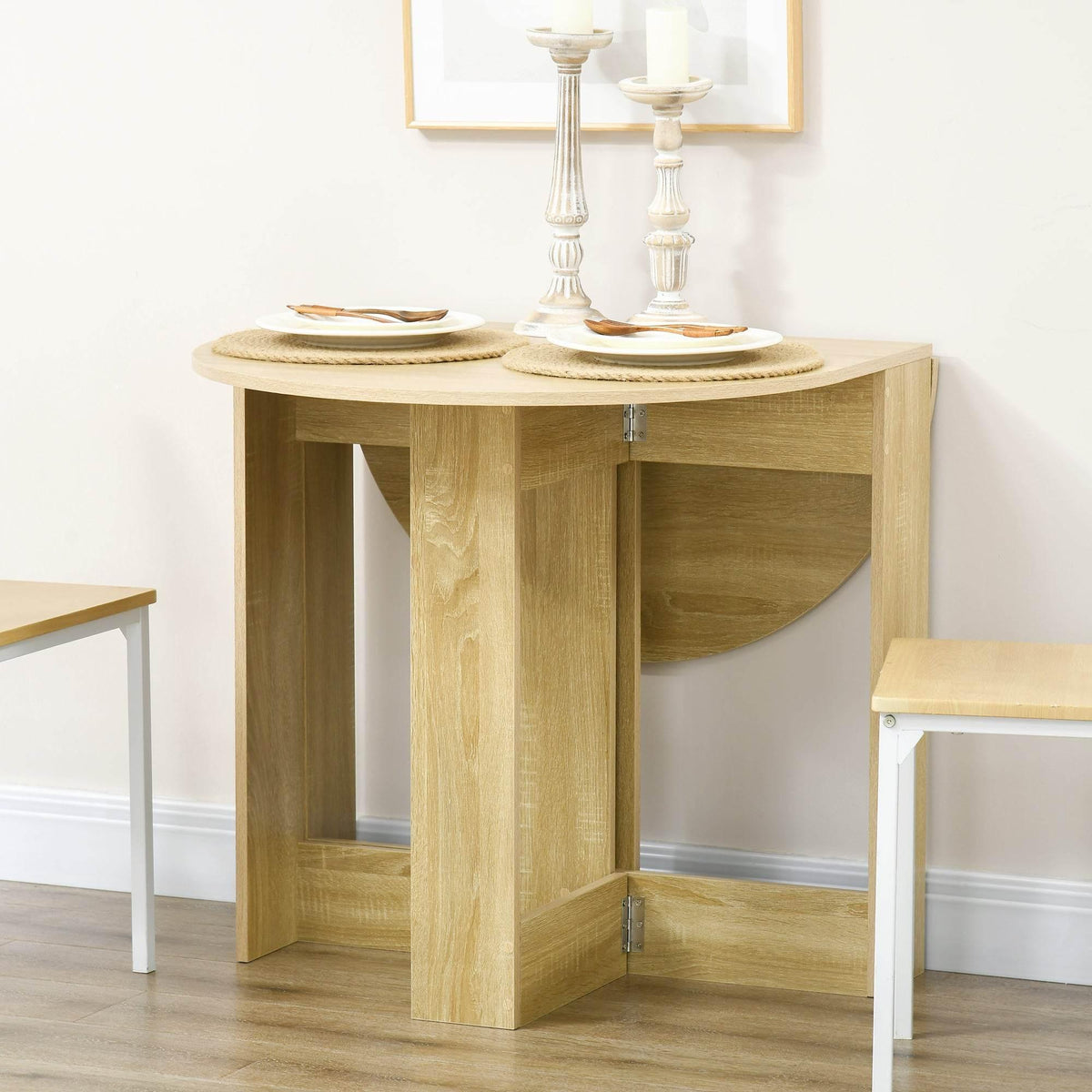 Light oak folding drop-leaf dining table with one leaf raised and open storage base